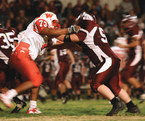 Clarendon's Jacob Pigg tries to hold off a Wellington Skyrocket during the fourth quarter of last Friday's game.