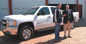 Clarendon First Assistant Fire Chief Kelly Hill (left) receives the keys to a 2011 Chevy Silverado from State Sen. Kel Seliger. The truck was donated to the local fire department by Chesapeake Energy Corp. ENTERPRISE PHOTO / ROGER ESTLACK