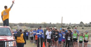 Clarendon Lion Jared Eggemeyer raises the starting horn to kick off the first Chance Mark Jones Memorial 5K Walk/Run Saturday as more than 200 participants crowd toward the starting line. Enterprise Photo / Roger Estlack