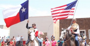 Chance McAnear and Cedar Stevenson present the colors during the July Fourth parade. Enterprise Photo / Roger Estlack