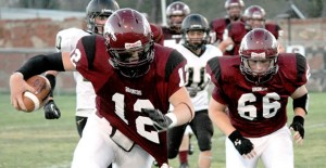 Bronco Zack Laroe runs the ball during the game with Vega last Friday with assistance from Montana Hysinger.  Enterprise Photo / roger Estlack