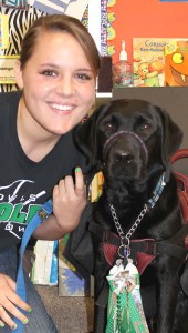 Kortney Burton with her service dog CorKey, who is sporting a Hedley Homecoming mum. Enterprise Photo / Kari Lindsey