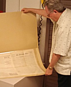 Dr. Monte Monroe examines the first issue of The Clarendon News, dated June 1, 1878. Enterprise Photo / Roger Estlack