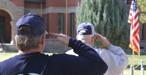 Veterans Joe Hall and Jimmy Swinney, both of Clarendon, salute the flag during a Veterans Day service at the Donley County War Memorial Monday morning. Five separate services honoring the men and women who have served America in the armed forces were held this week, two in Hedley, one on the Courthouse Square, one at Clarendon College, and another at Clarendon ISD. Enterprise Photo / Roger Estlack