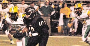 Senior quarterback Chance McAnear carries the ball in the Broncos playoff game against New Deal in Amarillo last Friday. 