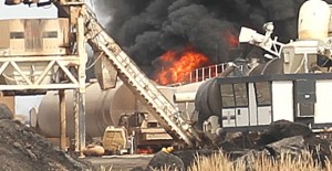 Flames shoot up from a diesel-fueled fire at a road construction plant west of Clarendon last week. The damage from the fire is estimated between $1.5 and $2 million. Enterprise Photo / Roger Estlack