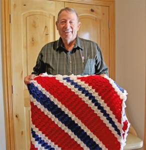 Pastor Dave Stout with Nancy Davis’ prayer blanket. Enterprise Photo / Tara Allred