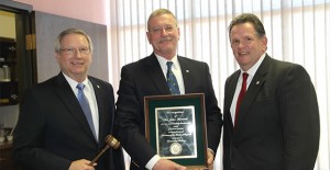 Donley County Judge-elect John Howard (center) received a plaque for his service to the Clarendon College Board of Regents after he resigned from his post as chairman of that board last Thursday. Also shown here is new Chairman Jerry Woodard and CC President Robert Riza. Enterprise Photo / Roger Estlack