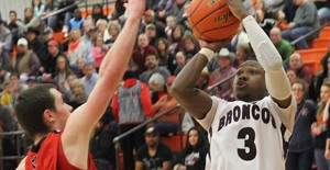 Clarendon’s Charles Mason shoots for three during the Broncos’ playoff match with Gruver last Tuesday. Enterprise Photo / Roger Estlack