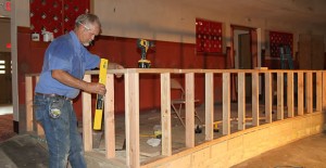 Leo Brewer works on the new handicapped seating area at the Mulkey Theatre Tuesday afternoon. Enterprise Photo / Roger Estlack