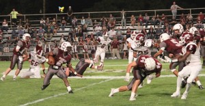 Keandre Crotez makes his way down the field for the Broncos as Caleb Cobb blocks a Tulia Hornet during last Friday’s game. Enterprise Photo / Roger Estlack