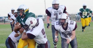 Junior Clay Koetting helps take down a Wolverine during Friday’s game against Spring Lake-Earth. Courtesy photo / Ursula Hamilton, Olton Enterprise