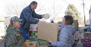 Bread of Life volunteer Steve Carter loads boxes for ministry coordinator Katherine Monroe (right) and fellow volunteer Steve Reynolds (left) during preparation for Monday’s distribution. The five-year-old ministry serves between 160 and 175 families each month. Enterprise Photo / Roger Estlack