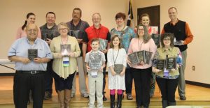 Representatives of the winning newspapers at the Panhandle Press Convention last Saturday were (back) Robin Patterson of Dumas, Michael Wright of Dumas, John Carson of Hereford, Roger Estlack of Clarendon, Ashlee Estlack of Clarendon, Ginger Wilson of Childress, Rob Langrell of Clovis, (front) Jessie Frausto of Dumas, Wanda Brooks of Dumas, Ben Estlack of Clarendon, Ella Estlack of Clarendon, Mary Smithee of Canadian, and Bev Odom of Wellington. Enterprise Photo / Morgan Wheatly