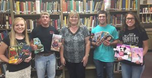 Donley County 4-H First Vice President Alysse Simpson, President Blaine Ellis, Second Vice President Clint Franks, and Third Vice President Jencie Hernandez present books to Clarendon School Librarian Buffie Smith.  Courtesy Photo 