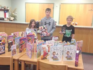 Donley County 4-H members Kennady Waldrop, Grayson Waldrop and Tyler Harper present books to the Hedley School Library. courtesy photo