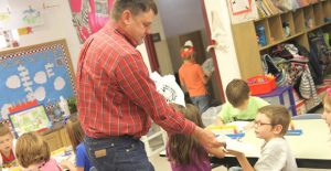 Clarendon’s Gret Betts hands out tooth decay prevention kits to local first grade students recently. The free kits were accompanied by a lesson in dental hygiene by school nurse Debbie Thompson. Enterprise Photo / Roger Estlack