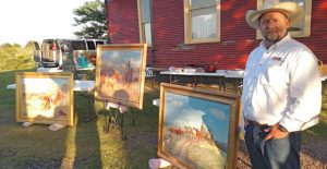 Michael Grauer shows a Harold Bugbee triptych during the annual Saints’ Roost Museum members’ appreciation dinner last Friday. Enterprise Photo / Roger Estlack