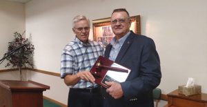 Mayor Sandy Skelton presents a plaque to former mayor Larry Hicks during a reception honoring Hicks’ service Saturday at the First United Methodist Church. Enterprise Photo / Roger Estlack