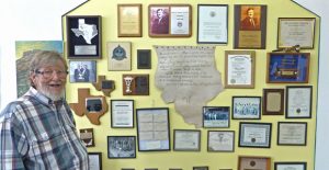 Dr. Keith Hudson (a.k.a. Buddy Hudson to his hometown friends, a graduate of Clarendon High School and a distinguished alumnus of Clarendon College, stands with some of his many awards. Hudson retired from a successful career as a dentist earlier this month. Courtesy Photo / Goldthwaite Eagle