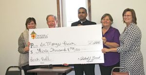 Kim Richards of the Amarillo Diocese presented a check for $30,000 to St. Mary’s Catholic Church Sunday to help retire some of the debt on the new Parish Hall. The funds were donated at the annual diocese gala for the benefit of the Clarendon church. Also pictured here are Bishop Patrick J. Zureck, Father Arokia Raj Samala, and St. Mary’s parishioners Denise Bertrand and Lindy Craft. An open house for the new hall will be held Sunday, Dec. 4, from 1 to 4 p.m.Enterprise Photo / Roger Estlack